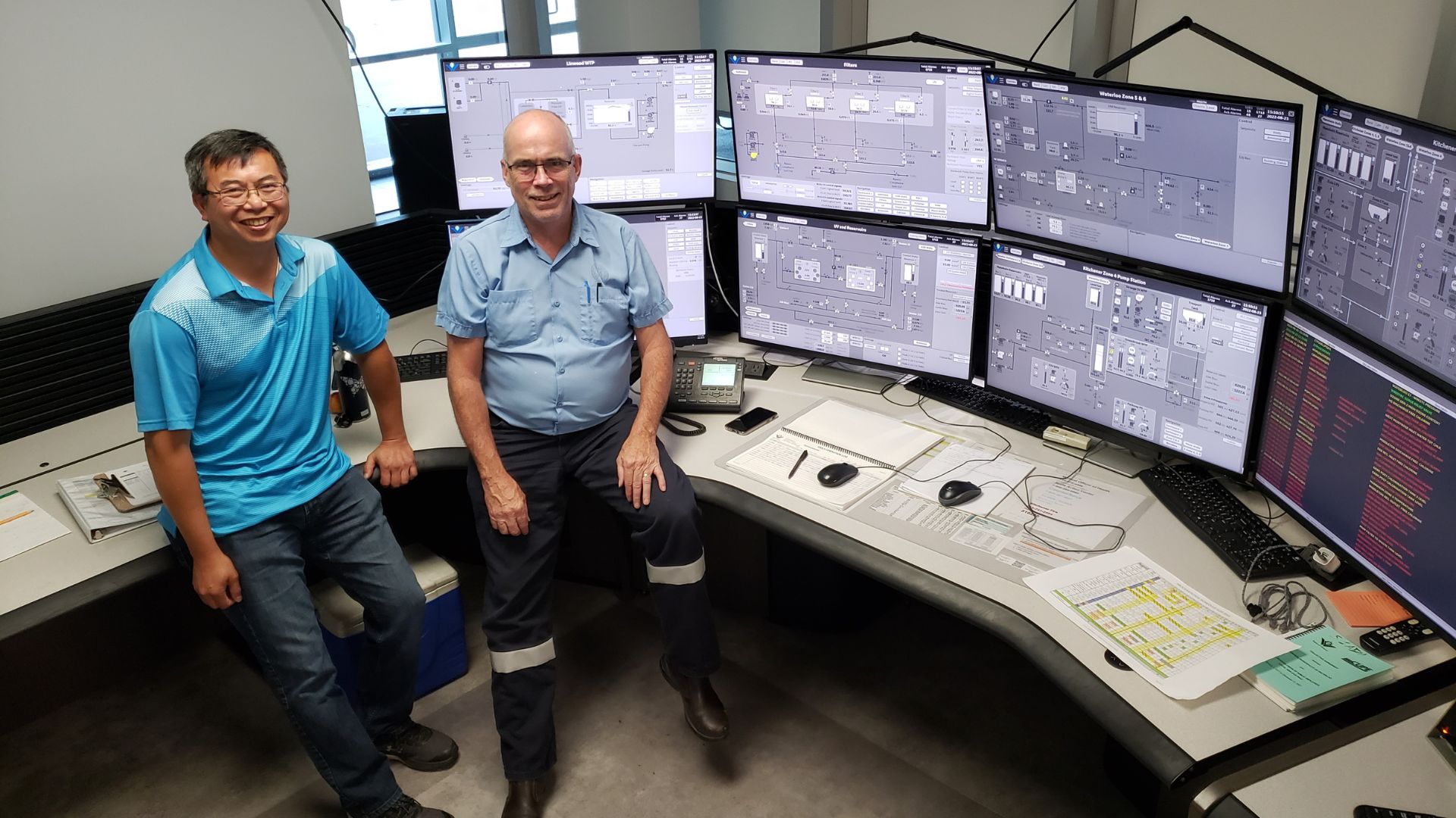 An image of regional employees in front of computers