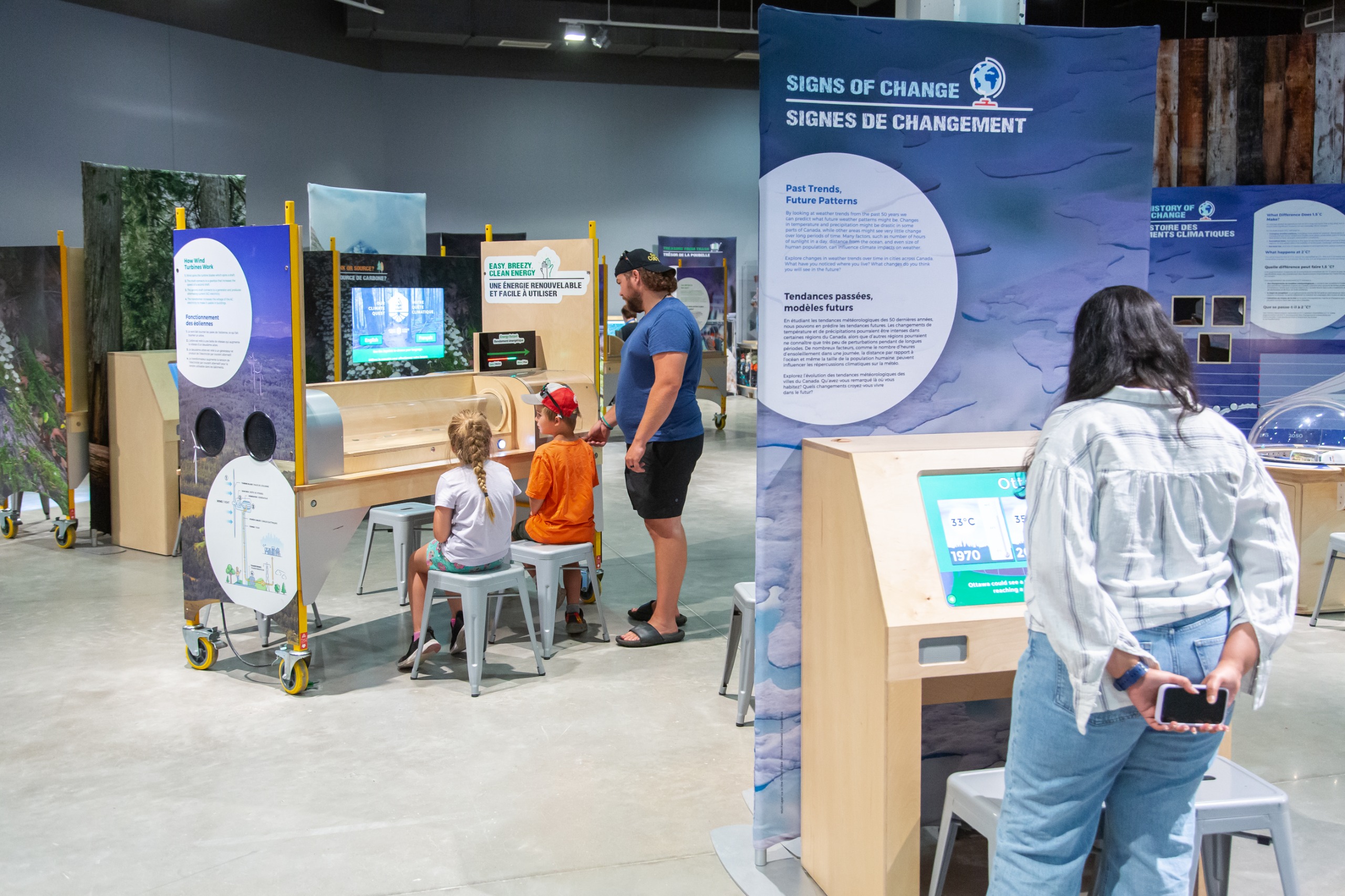 adults and children looking at a climate change exhibit