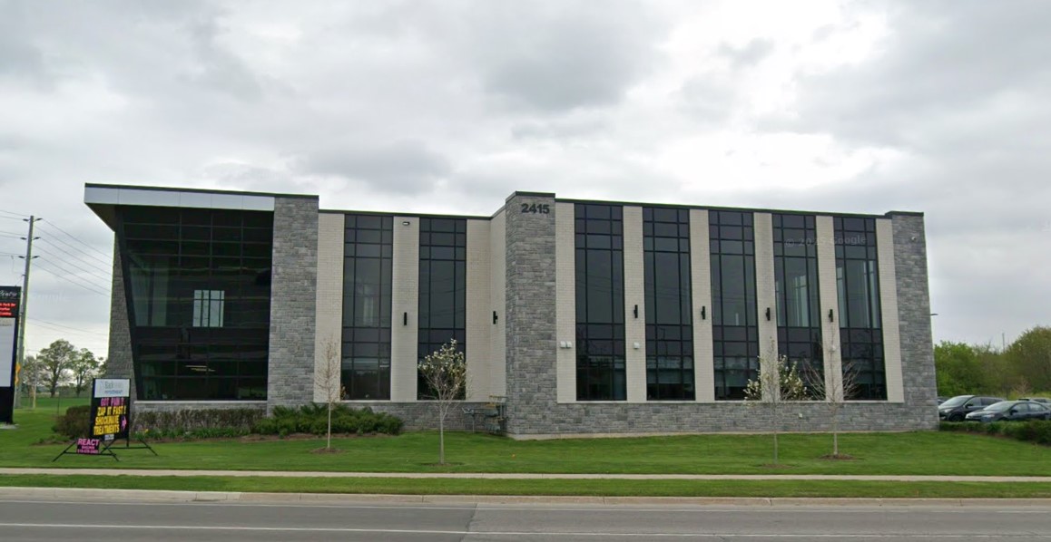 Image of the front of an industrial/commercial building, addressed 2415 University Ave E. 