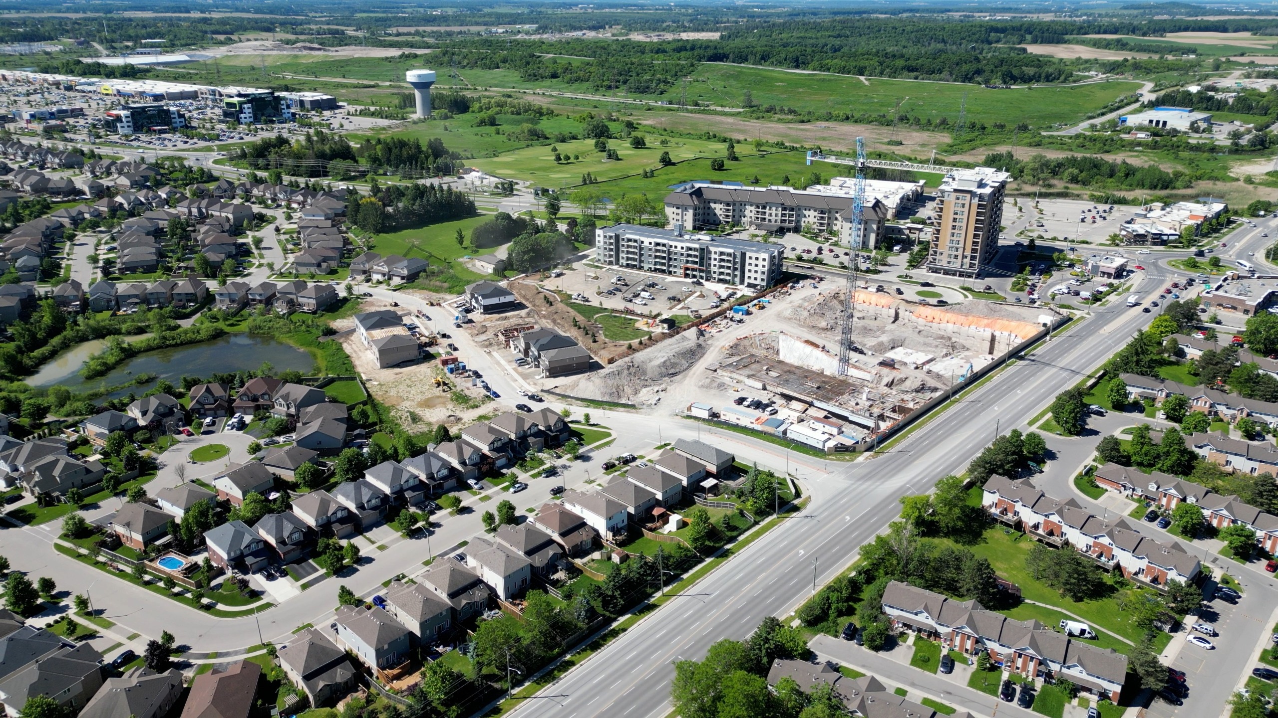  homes and apartments with an apartment being built in the background.