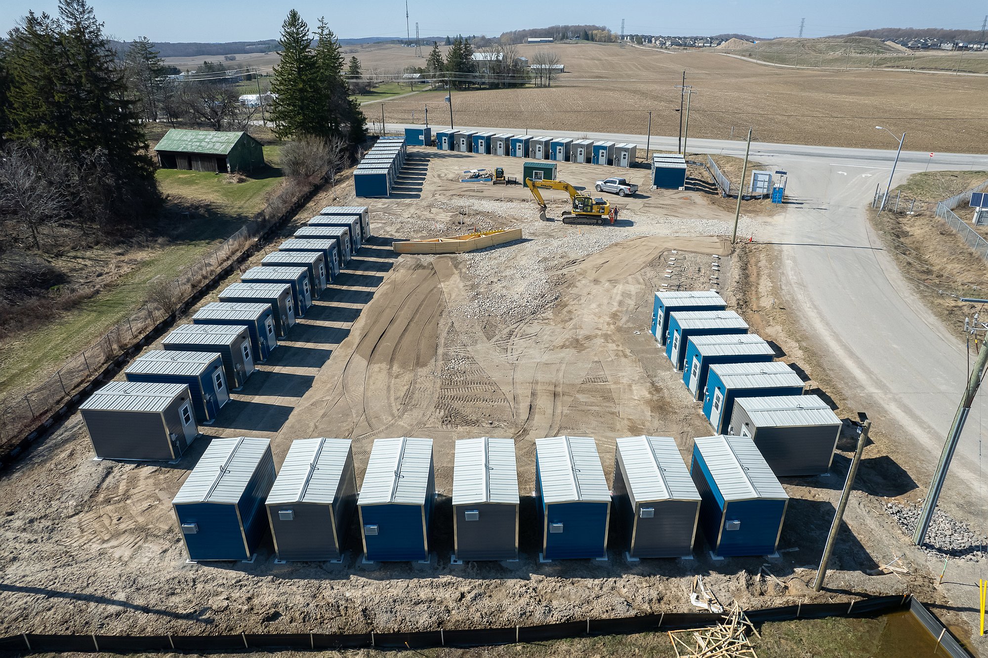 Aerial shot of the site shows cabins on the site. 