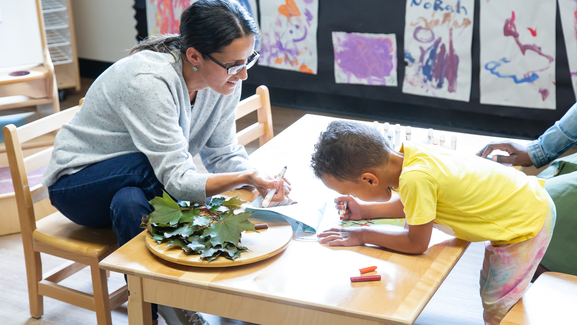 Woman playing with child.