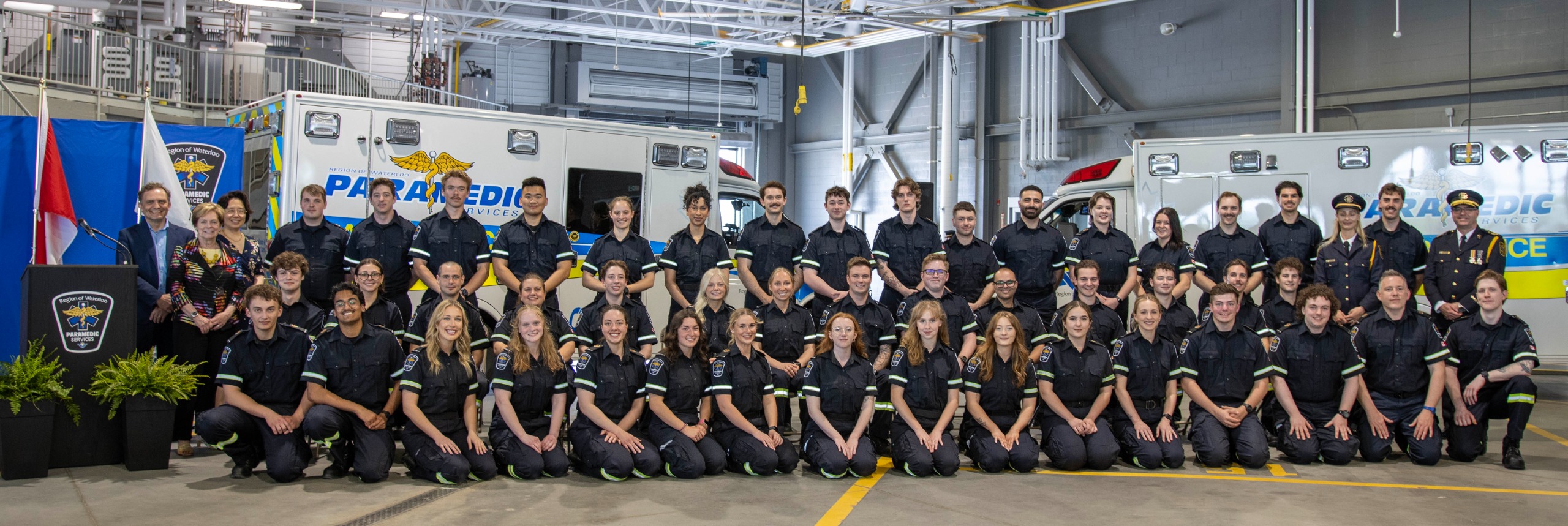 More than 47 new paramedics pose for a picture after being recognized at a ceremony 