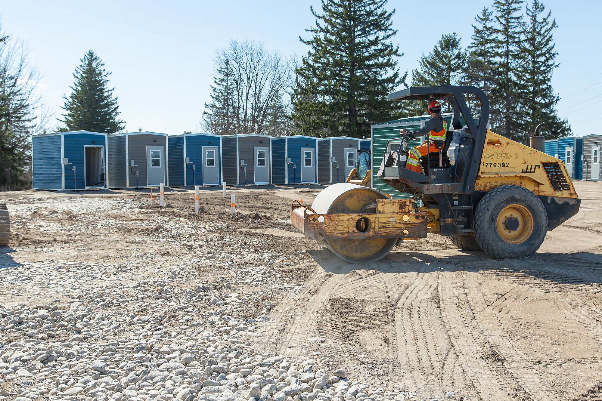 Construction equipment smooths the site at 1001 Erb's Road. Individual cabins are pictured in the background. 