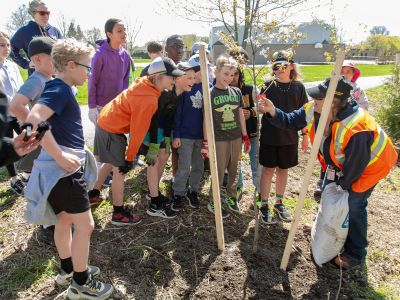 Students around a newly planted tree along with a Waterloo staff member 