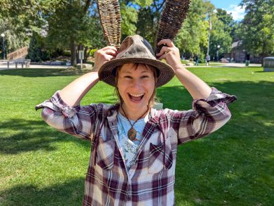 Community member showing their woven art