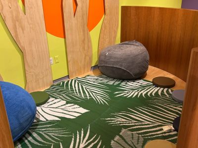 A cozy corner with carpet and cushions